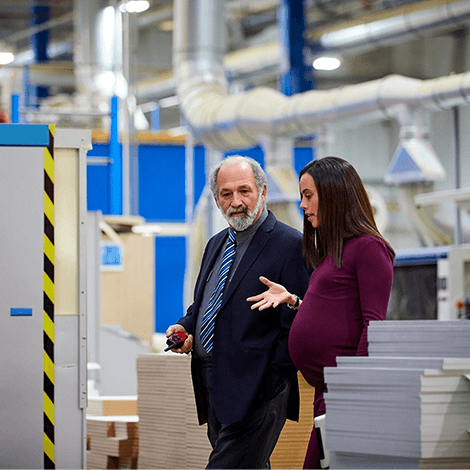 Pregnant employee talking to colleague