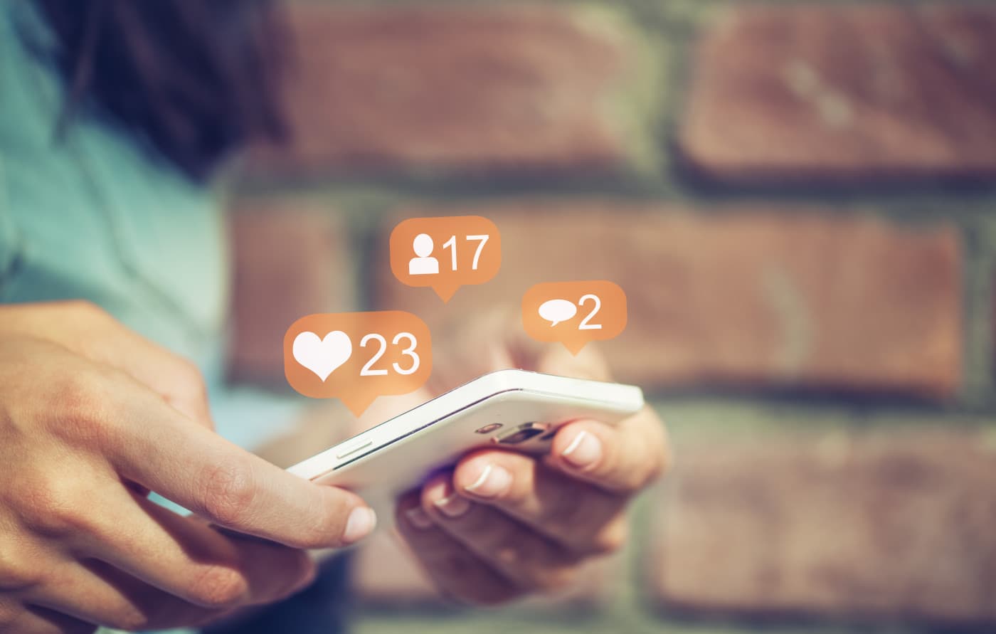 Woman using phone surrounded by social media icons