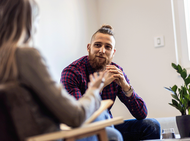 Man talking to a therapist about mental health issues