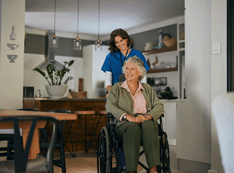 Carer helping an elderly woman in her home